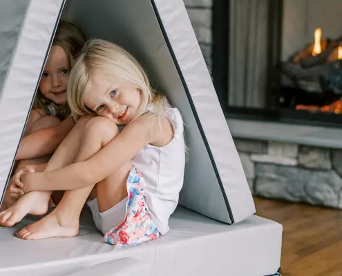 Children playing near a propane fireplace