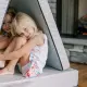 Children playing near a propane fireplace