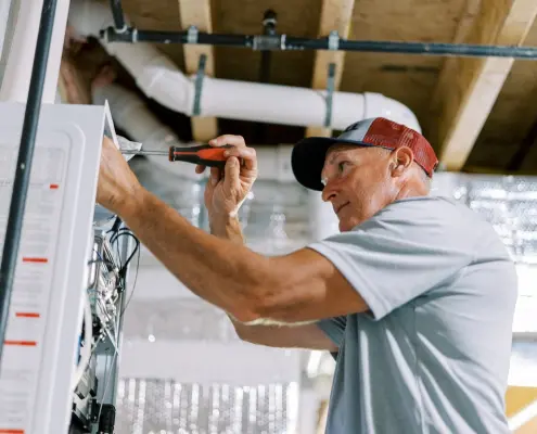 tankless water heater being serviced by technician