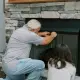 technician inspecting propane fireplace during service plan visit