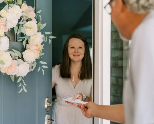 A propane provider handing a delivery ticket to residential customer