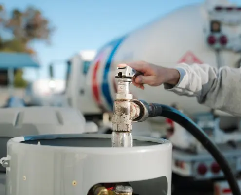 Hall technician refills propane tank
