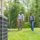 HVAC technicians walking up to an outdoor unit with tools