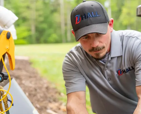 HVAC technician working on an outdoor unit