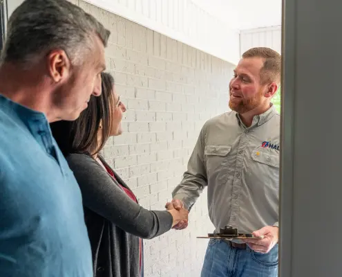 air conditioning expert shaking customers hand