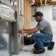 Hall HVAC technician working on an indoor furnace