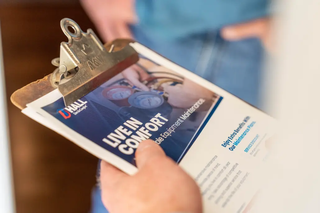 Clipboard with "Live In Comfort" and Hall Propane logo