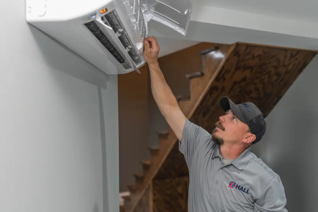 Hall HVAC technician working on a mini-split