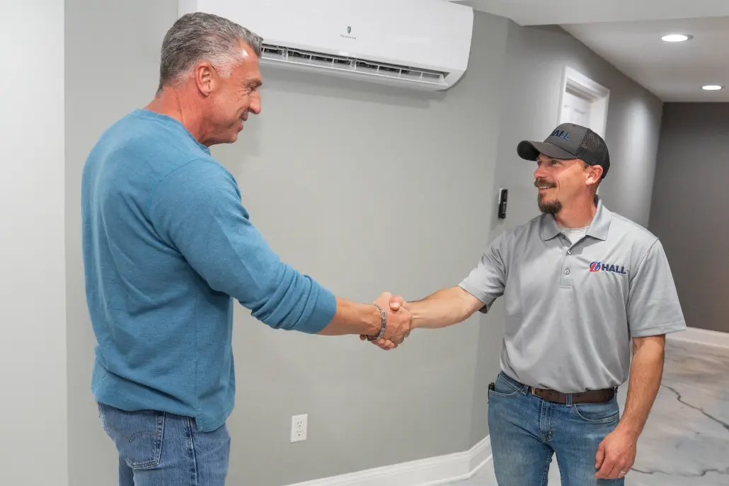DSC04455 Hall HVAC shaking customer's hand in front of a mini-split
