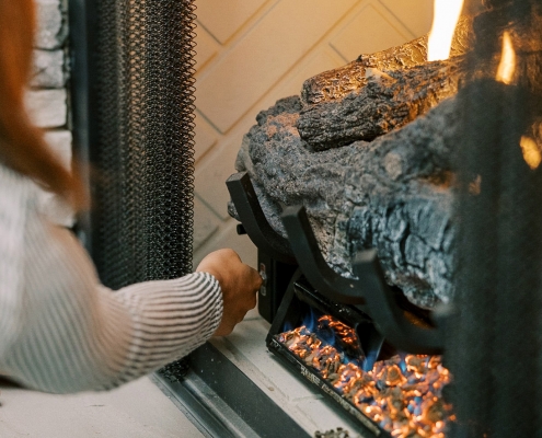 Residential Hall customer lighting a propane gas fireplace