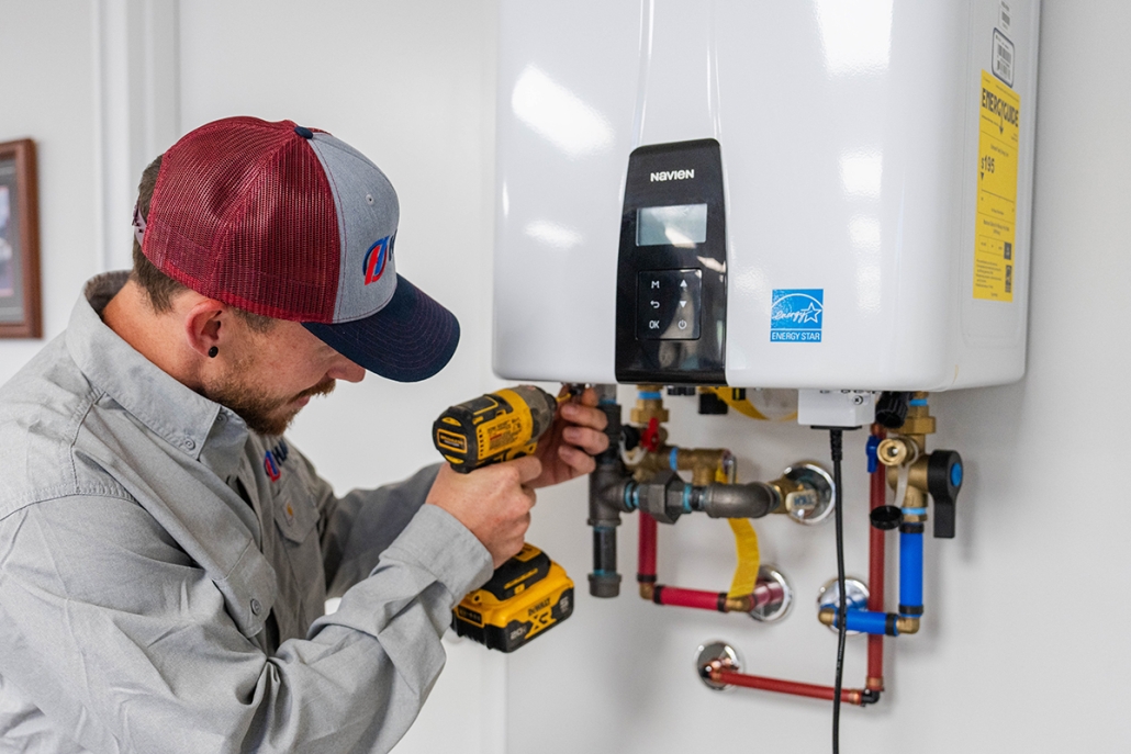 Hall technician servicing a Navien tankless hot water heater