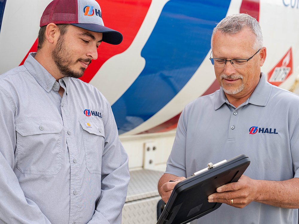 Two Hall service technicians looking at a tablet