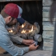 Hall technician servicing a gas log fireplace