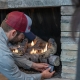 Hall technician servicing a gas log set.