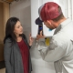 Hall technician showing tankless water heater to customers