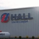 Hall "Live In Comfort" sign on the side of a steel building.